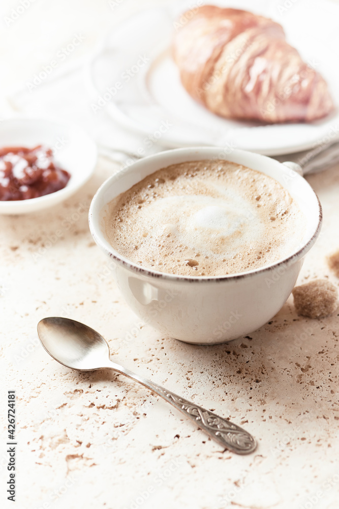 Coffee with milk on bright stone background. Close up. Coffee with milk on bright stone background. Close up.
