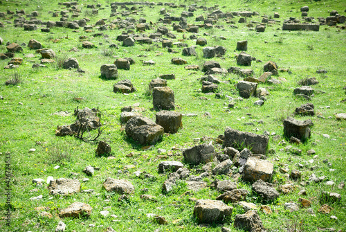 Large pieces of building material on the grass. Pieces of concrete on the field.