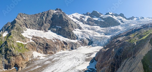 Amazing panorama of the glacier with snow between the mountain ranges