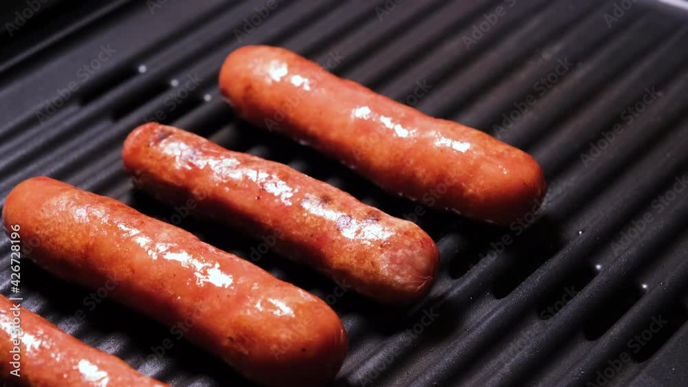 Removing sausages from the grill close up. 4K resolution video. Delicious Fried Roasting Grilled Meat Dish Ready For Picnic or Party. Cooking Fast Food Take Away Sausages Meal. Removing sausages from the grill close up. 4K resolution video. Delicious Fried Roasting Grilled Meat Dish Ready For Picnic or Party. Cooking Fast Food Take Away Sausages Meal.