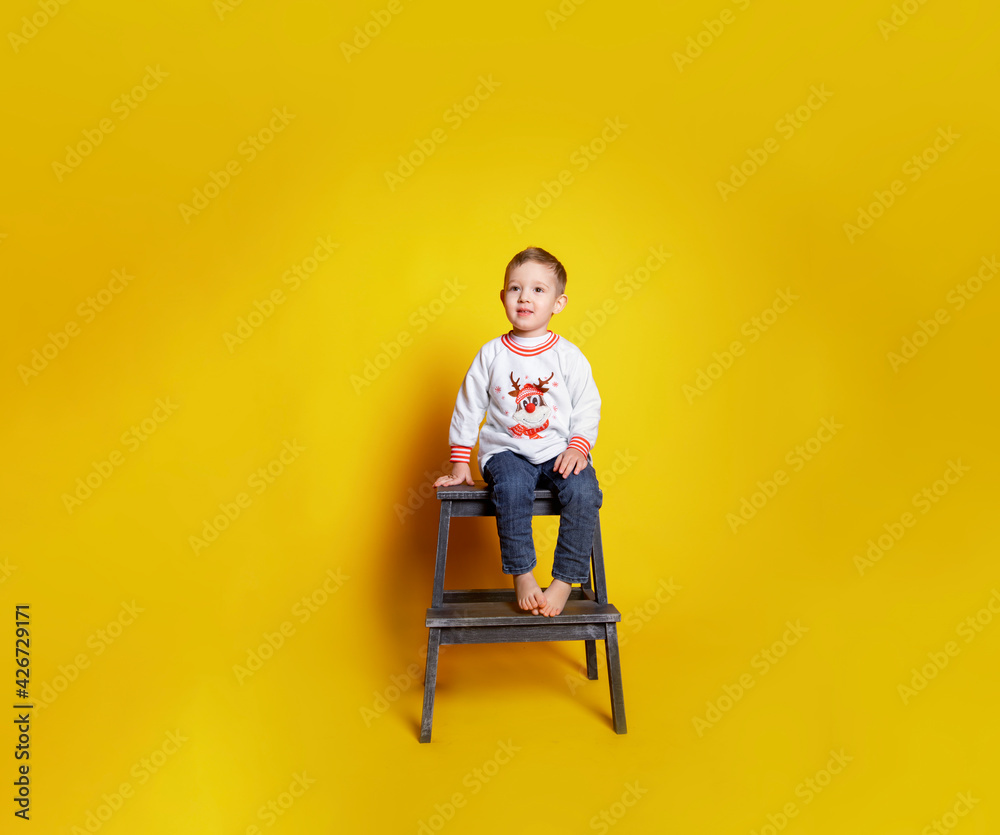 child in jeans and a white sweater child in jeans and a white sweater