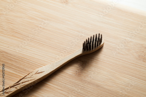 Kit of toothbrushes on the rustic wooden table in the bathroom. Warm and welcoming atmosphere. With neutral and isolated background. Spa concept. Personal hygiene concept. 