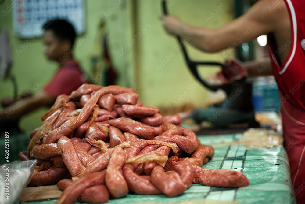 Unrecognizable man making sausages for selling on street food market