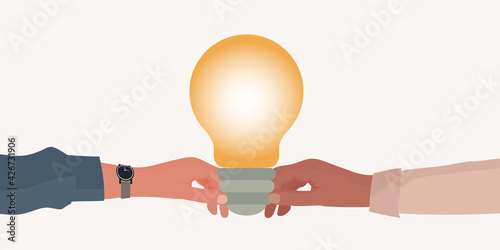 Metaphor. Hand holding a light bulb giving it to another hand. Teaching concept. Teacher coach mentor leader or instructor. Training course. Seminar or Conference. Learning. Workshop