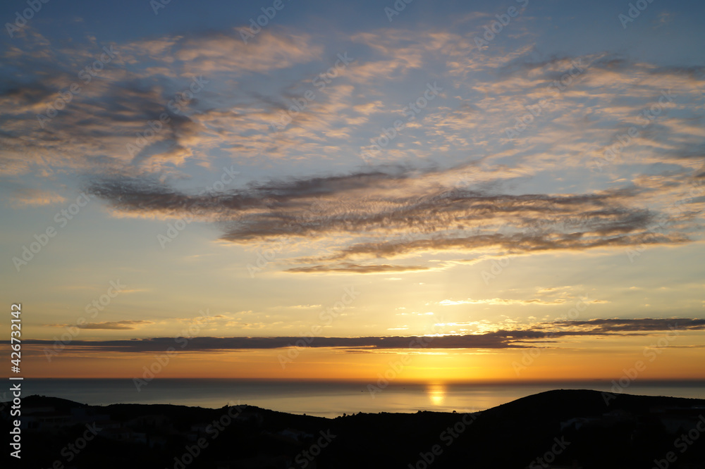 romantic golden sunrise over the sea and subtle cloud structure