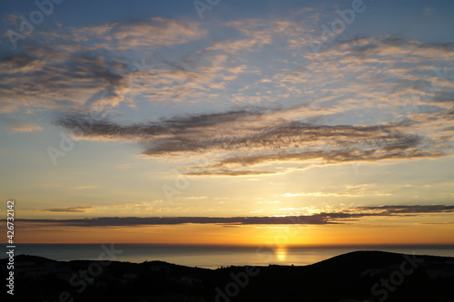 romantic golden sunrise over the sea and subtle cloud structure