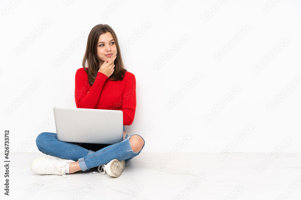 Tenaager girl working with pc isolated on white background looking to the side Tenaager girl working with pc isolated on white background looking to the side