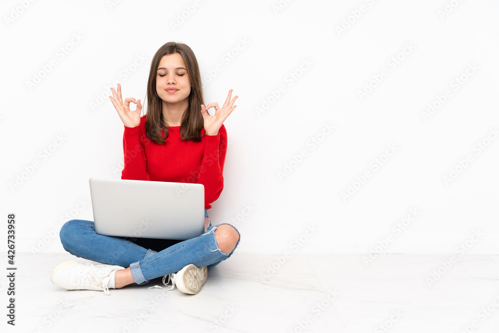Tenaager girl working with pc isolated on white background in zen pose Tenaager girl working with pc isolated on white background in zen pose
