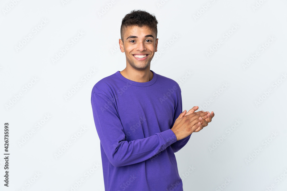 Young brazilian man isolated on white background applauding Young brazilian man isolated on white background applauding