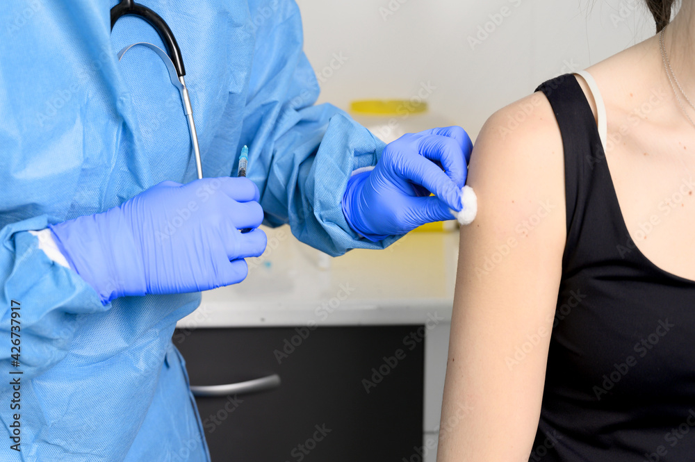 Close up of young woman getting vaccinated, coronavirus concept. High quality photo Close up of young woman getting vaccinated, coronavirus concept. High quality photo