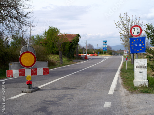 Stop sign on the road in Miren, closed road Slovenia - Italy covid restrictions.
