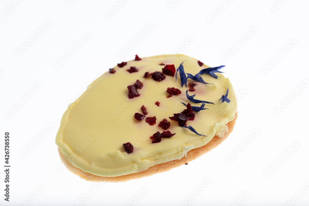 Egg shaped biscuit cookie with white chocolate, dried raspberries and dried blue rye flowers Egg shaped biscuit cookie with white chocolate, dried raspberries and dried blue rye flowers