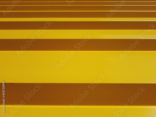 painted yellow ribbed panel background.