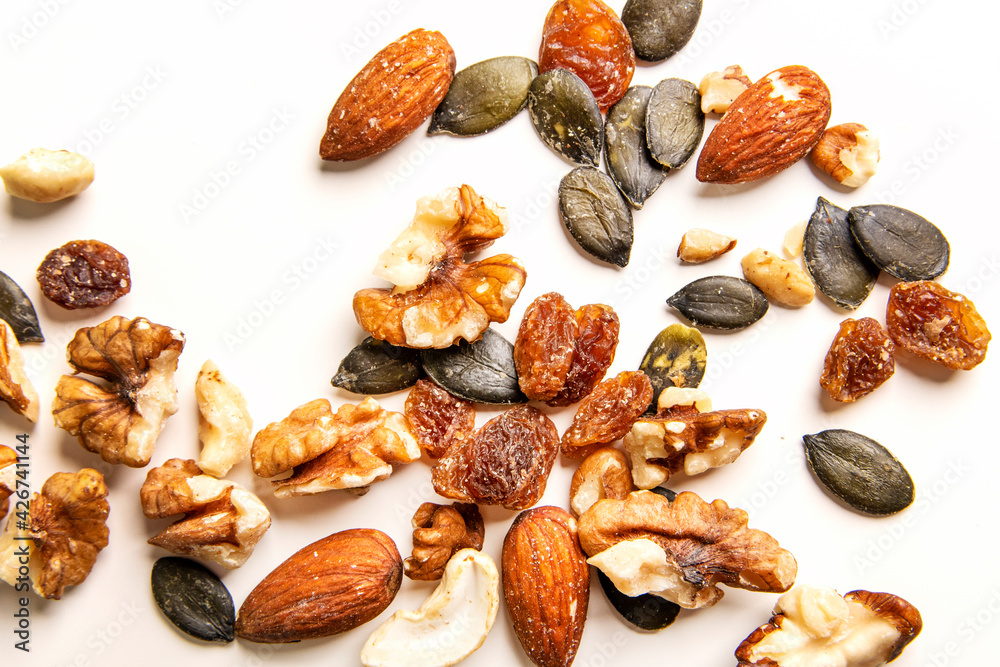 Various nuts on the white background. Selective focus, Top view. Various nuts on the white background. Selective focus, Top view.