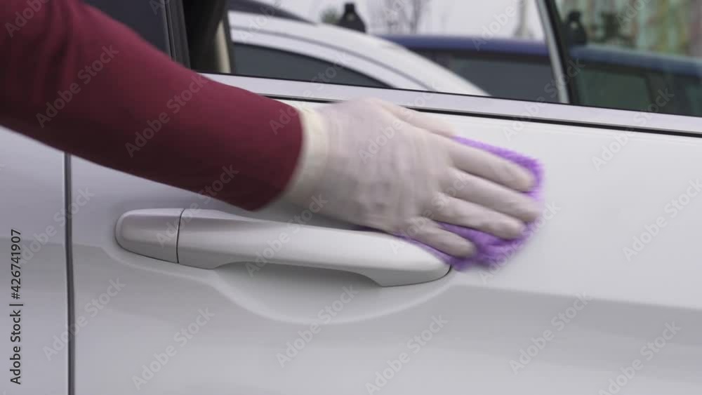 Man`s hand Disinfects Car Door Handles With Antibacterial Sanitizer and Wipe. Prevent the virus and bacterias on car sharing or transportation.Closeup Man`s hand Disinfects Car Door Handles With Antibacterial Sanitizer and Wipe. Prevent the virus and bacterias on car sharing or transportation.Closeup