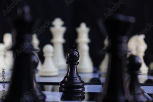 Game of chess. Chess is photographed on a chessboard.  Table games.  Strategy games.  Creative minimal concept. Strategy, management or leadership concept.  Business success concept. © LP