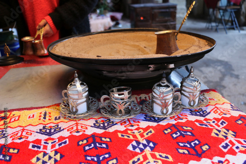 selective focus. Turkish coffee prepared by cooking in the sand. Turkish coffee is a symbol of Turkey. photo