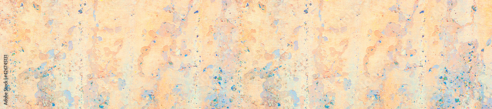 Panorama old concrete wall covered with pastel pale colorful paint.