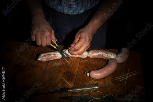 hands of man making salame