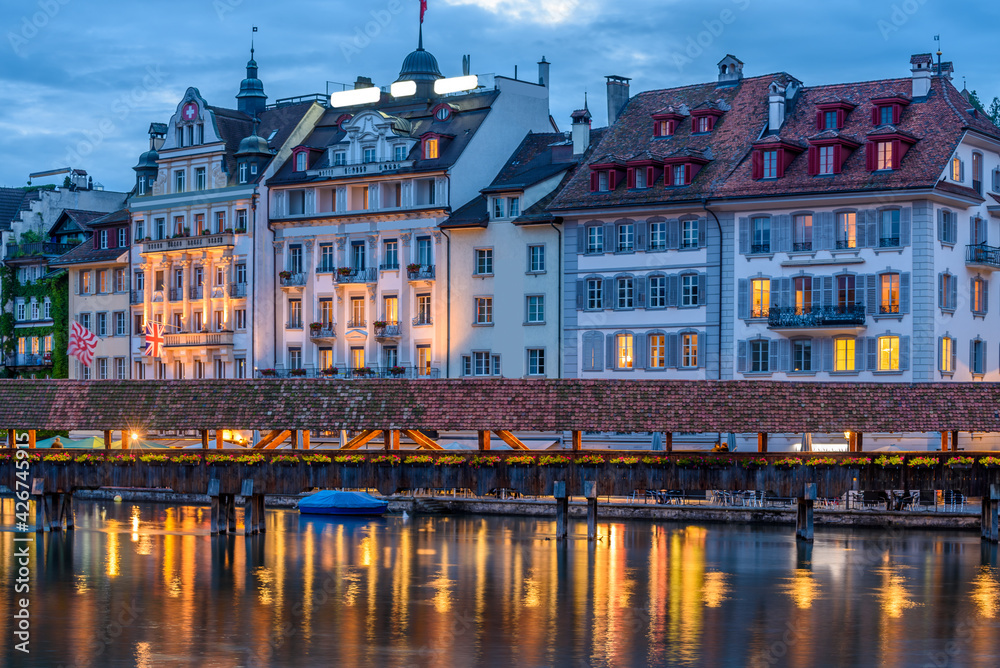 Night view towards Chapel Bridge (Kapellbruecke) together with the octagonal tall tower (Wasserturm) it is one of the Lucerne's most famous tourists attraction