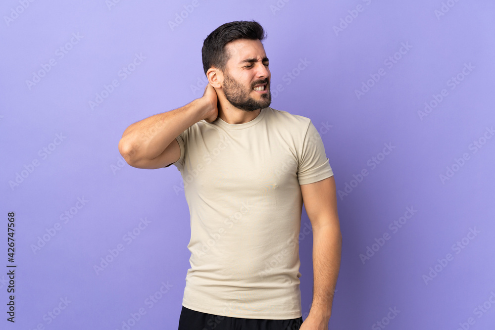 Young handsome man with beard over isolated background with neckache Young handsome man with beard over isolated background with neckache