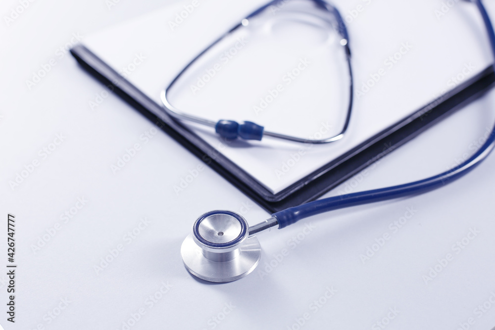 Stethoscope and tablet for recording patients on gray background Stethoscope and tablet for recording patients on gray background