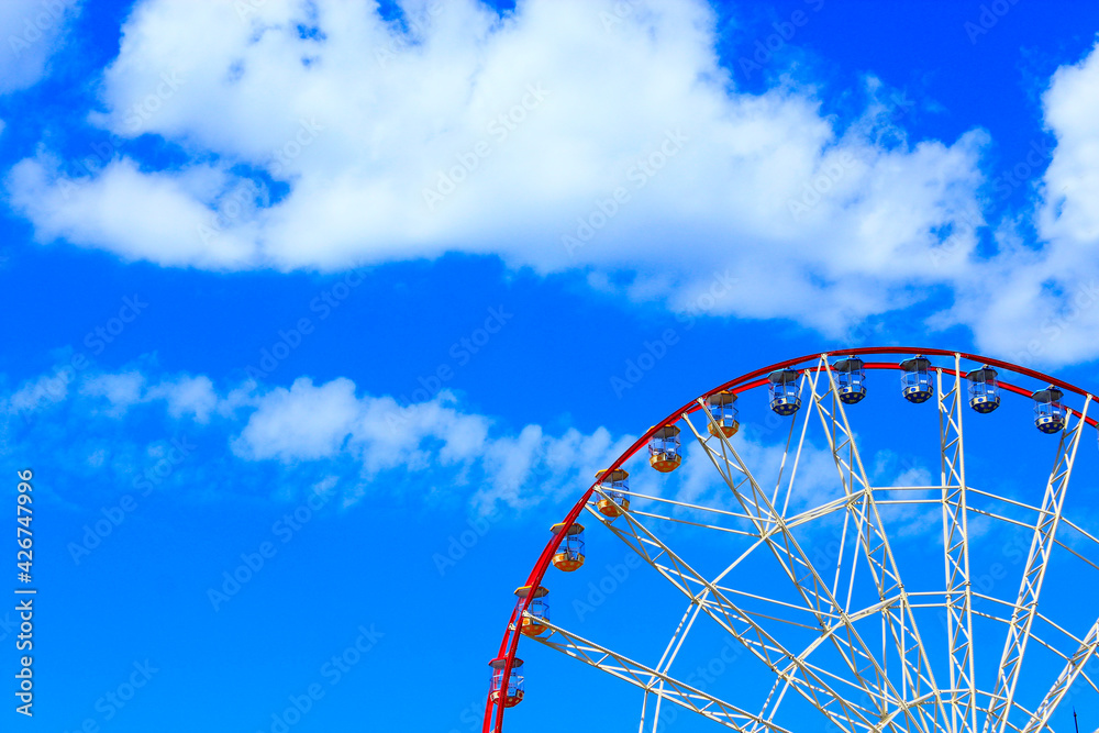 People ride a ferris wheel in the city park