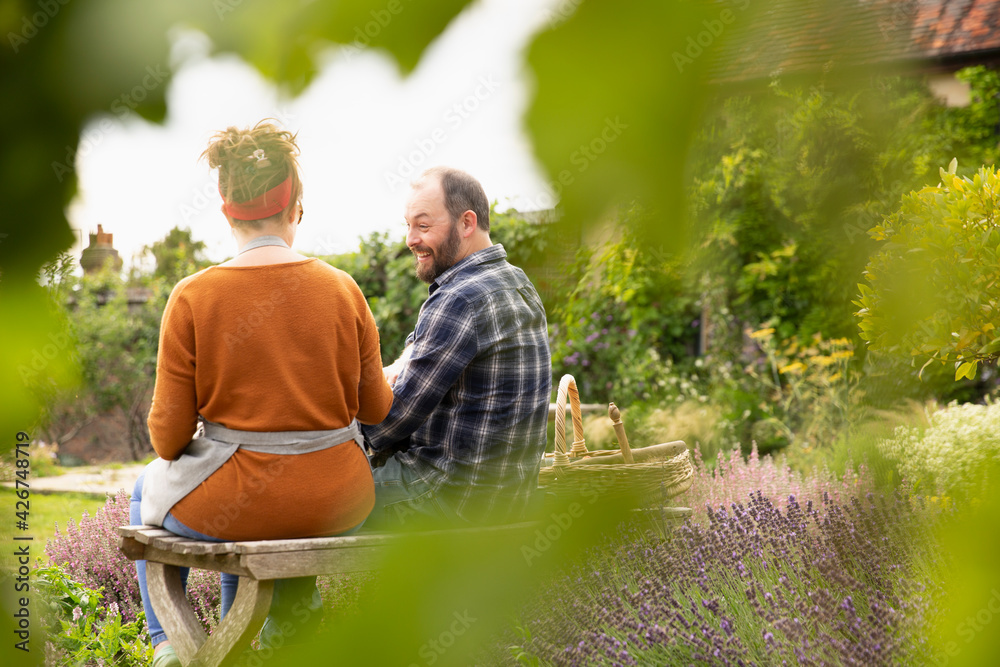 Happy couple taking a break from gardening in backyard Happy couple taking a break from gardening in backyard