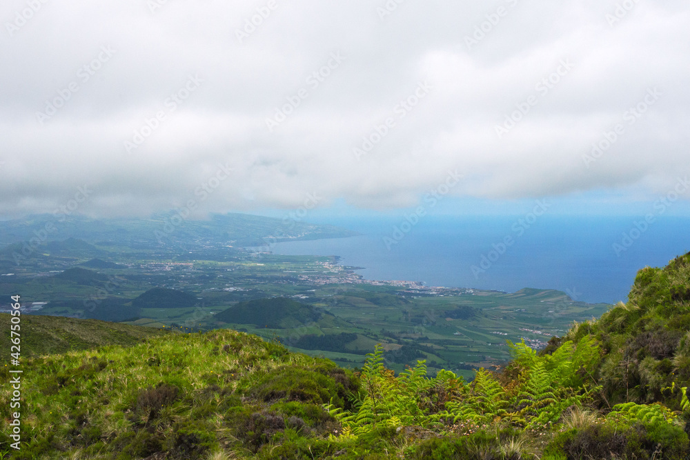 Gray rain clouds over hills and lakes in Sao Miguel island. Travel to the Azores.