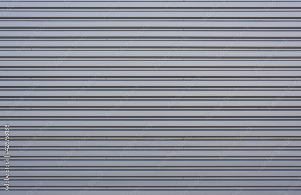 corrugated iron sheet, aluminum Facade of a warehouse as background texture corrugated iron sheet, aluminum Facade of a warehouse as background texture