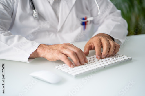 Close up of a Doctor working in his office or home.
