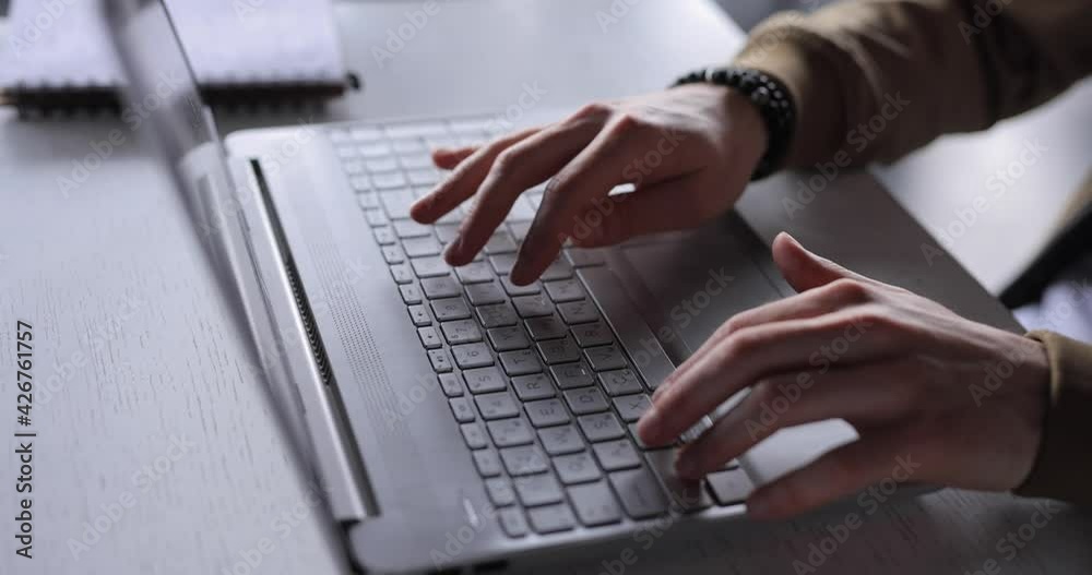 Closeup freelancer male hands typing text working on laptop keyboard Closeup freelancer male hands typing text working on laptop keyboard