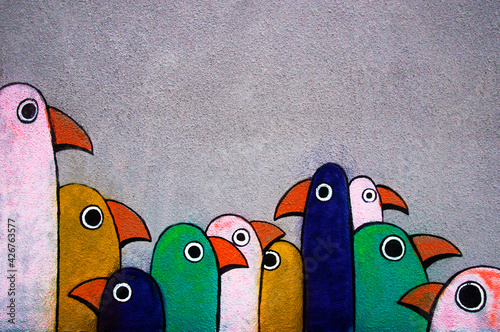 Fotografie Street graffiti: minimalist multi-colored pogues in a row on a gray wall