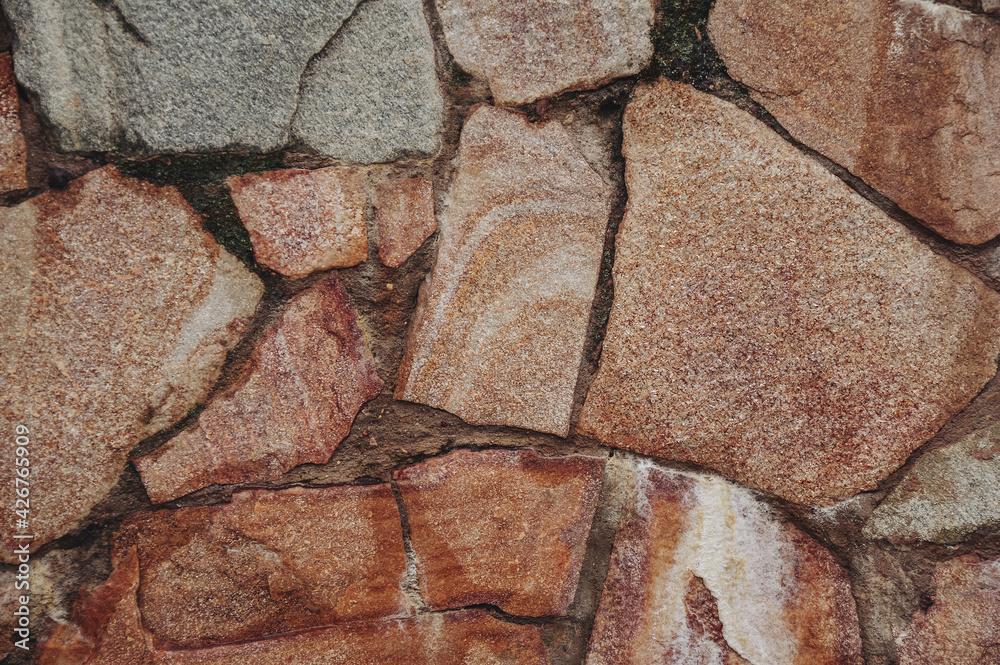 A wall of stone. The texture and pattern of the stones. Natural and eco-friendly material for construction. A wall of stone. The texture and pattern of the stones. Natural and eco-friendly material for construction.
