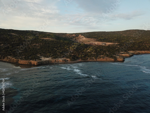 Beautiful view of the Cyprus landscape from above with a drone. Juniper forest and rocky shore. Mediterranean sea at dawn. The nature reserve of the Akamas Peninsula