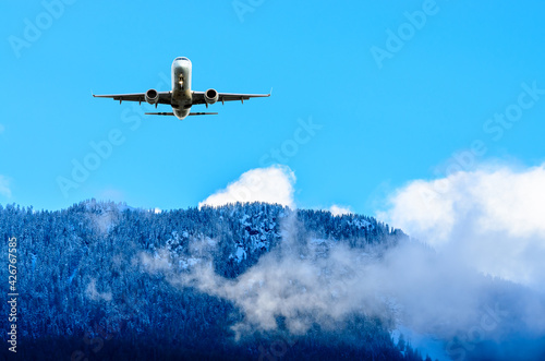 flight of the airplane (jet) over beautiful sky and snow mountains