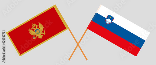 Crossed flags of Montenegro and Slovenia. Official colors. Correct proportion