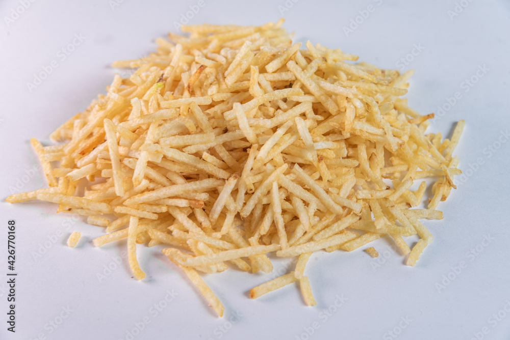 White bowl with potato straw on white background White bowl with potato straw on white background