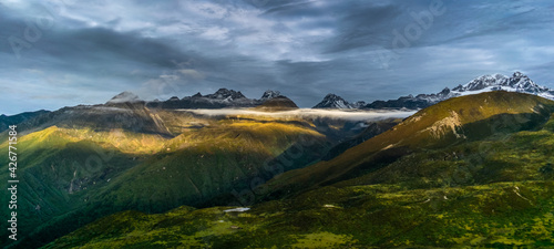 a beautiful mountain view with fog and clouds