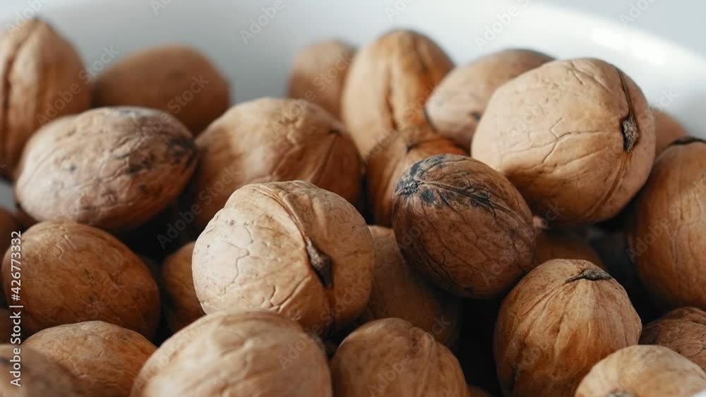 Walnuts in a white bowl. Whole walnut. Healthy Food. Walnuts in a white bowl. Whole walnut. Healthy Food.