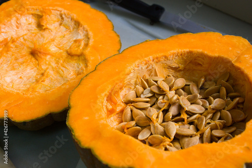 Close-up of a pumpkin split in half that has seeds