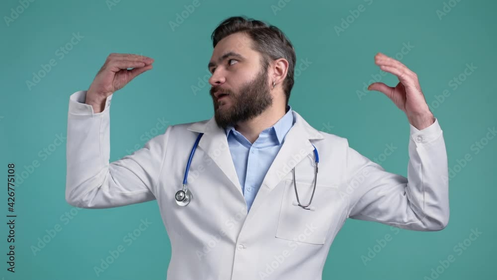 Handsome bored doctor man in medical coat showing bla-bla-bla gesture with hands and rolling eyes isolated on blue background. Empty promises, blah concept. Lier. Handsome bored doctor man in medical coat showing bla-bla-bla gesture with hands and rolling eyes isolated on blue background. Empty promises, blah concept. Lier.