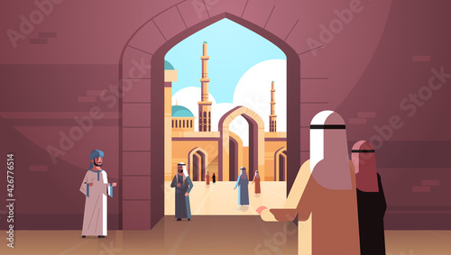 arab people coming to nabawi mosque building muslim religion concept rear view arabic prayers in traditional clothes ramadan kareem holy month horizontal flat