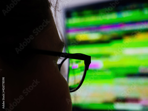 Woman wearing eyeglasses looking at the defected tv display photo