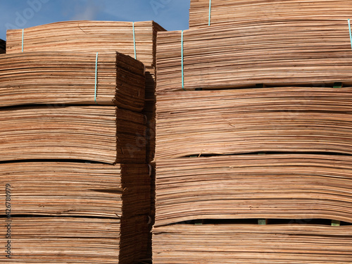 Two large Stacks of wood veneer for plywood at the mill