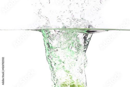 juicy green apple falls into the water on a white background, place under the text