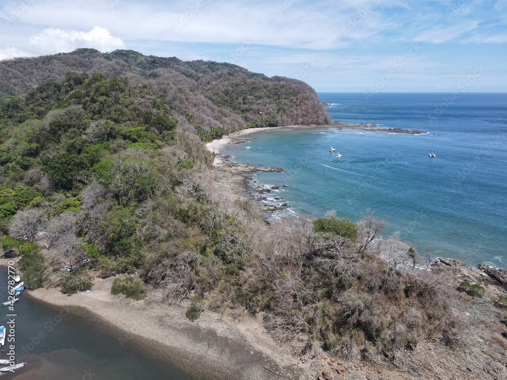 Lush Tropical Beach Paradise with blue water, great waves and rock formations in Malpais / Santa Teresa, Nicoya Peninsula Costa Rica Lush Tropical Beach Paradise with blue water, great waves and rock formations in Malpais / Santa Teresa, Nicoya Peninsula Costa Rica