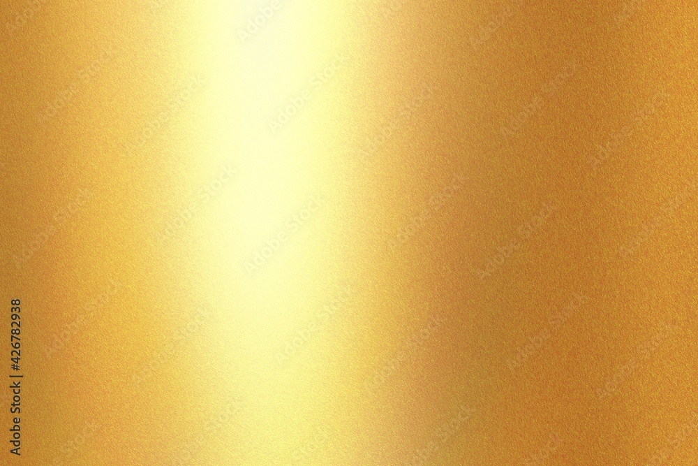 Light shining on gold painted metal wall with copy space, abstract texture background