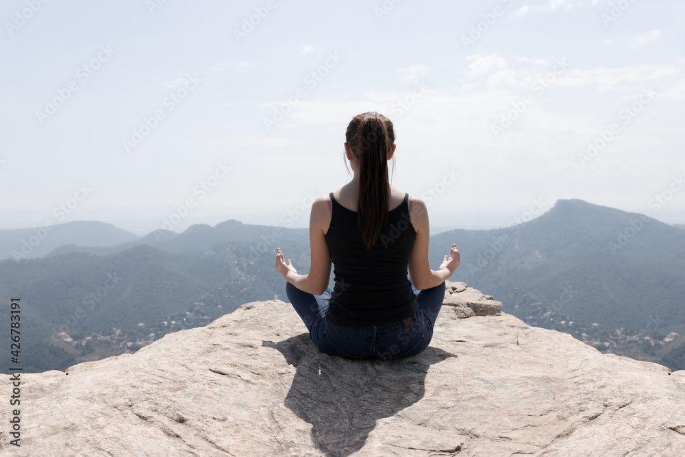girl doing yoga on the mountain