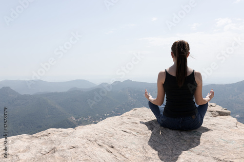 girl doing yoga on the mountain © Miguel